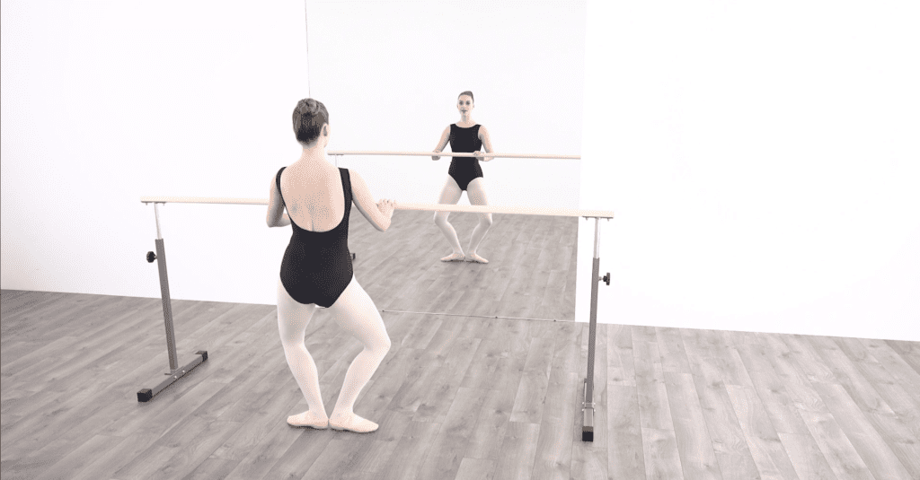 This online dance class mimics the perspective of being in a dance studio by watching the instructor from behind while facing a mirror.
